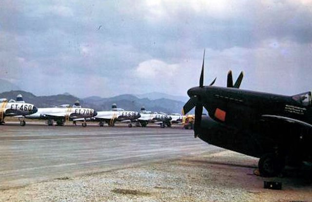 The flightline at Itazuke Air Base, Japan, 1950. The F-82 in the foreground belongs to the 69th All Weather Fighter Squadron, and the F-80s are assign