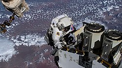 ISS-68 Josh Cassada prepares a roll-out solar array for its deployment (2)