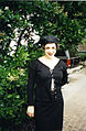 Woman dressed in black maxi skirt, top and hat, 1995.