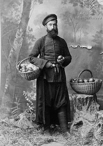 A kinto holding a basket of fruit, photo by Alexander Roinashvili