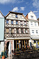 Half-hipped roof house with over-boarded half-timbering