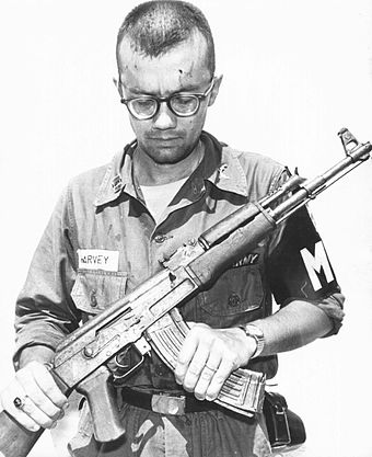 A US Army MP inspects a Soviet AK-47 recovered in Vietnam, 1968.