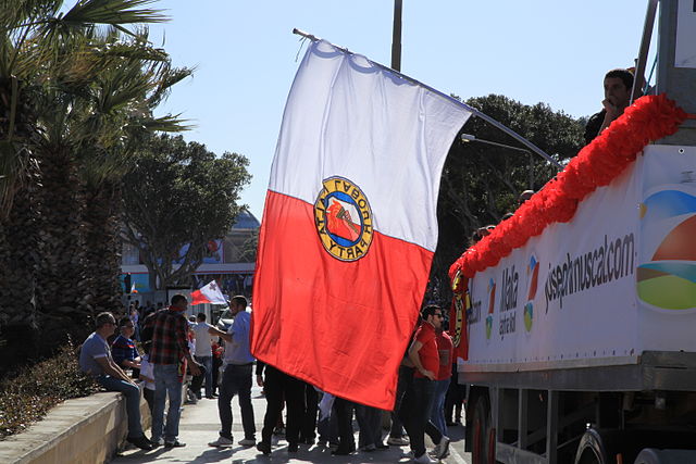 Emblem of the MLP adopted in 1949 on a flag. The emblem was changed in 2008 but it is still commonly seen at Labour meetings and events.[citation need