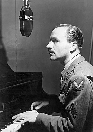 Blitzstein playing the piano beneath a BBC microphone