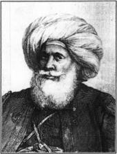 gravură alb-negru: portretul unui bărbos într-un turban