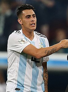 Forward Cristian Pavón, middle, of Argentina, holds up his new LA