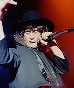 The band covered two Slade songs, "Cum On Feel the Noize" and "Merry Xmas Everybody", both of which were written by vocalist Noddy Holder (pictured) and bassist Jim Lea. Noddy Holder (modified).jpg