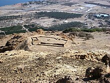 Excavated temple of Ein Gedi with background of modern Kibbutz and Dead Sea.