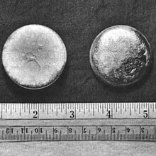Two shiny pellets of plutonium of about 3 cm in diameter