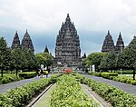 Symmetrically arranged stone buildings. The steep roofs are decorated with a large number of small stupas.