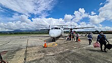 One of PAL Express' Bombardier Q400 sits at the airport's ramp as it disembarks passengers from MNL in May 2021. RP-C5907 at TUG.jpg