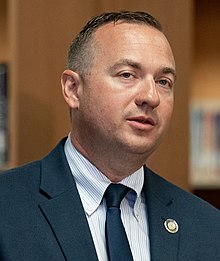 Rep. Peter Schweyer speaks at a press conference.jpg