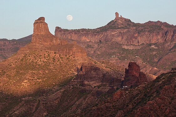 Full moon and the last touch of sun rays in rocks, landscape of Gran Canaria, Spain, July 26, one day before eclipse.