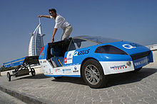 Louis Palmer standing in the Solartaxi. Solartaxi.jpg