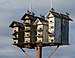 Starlings on a birdhouse (92039).jpg