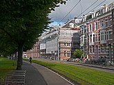 Street view of Sarphatistraat with green grass tram track; free photo Amsterdam, Fons Heijnsbroek 10-2021