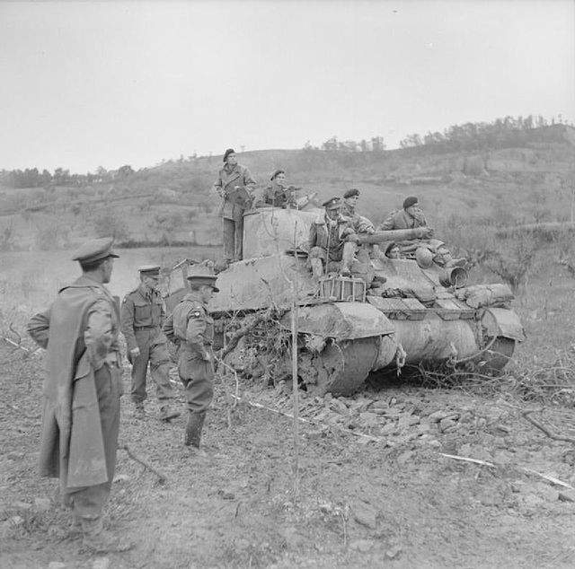 A Sherman tank of 3rd CLY negotiates a newly-laid road surface, constructed over soft ground by 1926 Basuto Company, Royal Pioneer Corps, in the advan