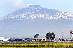 US Navy 030325-N-9693M-001 Sicily's volcano, Mt. Etna, is the backdrop for a U.S. Air Force C-5 and the air terminal of Naval Air Station (NAS) Sigonella.jpg