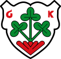 Gemeinde Gaukönigshofen In Silber aus einem roten Strunk wachsend eine grüne Staude mit drei Stängeln, daran je drei grüne Blätter.