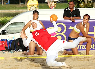 Woman wearing a burkini while playing beach handball, where uniforms typically are bikini or similar adapted sports wear. XOKA5718s (15794821896).jpg