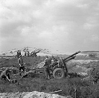 25 pounders of 430th Battery, 55th (Wessex) Field Regiment, Royal Artillery, near Hechtel in Belgium, firing in support of Guards Armoured Division in the bridgehead over the Maas-Schelde (Meuse-Escaut) Canal, 16 September 1944