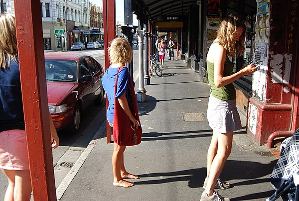 Barefoot woman in Brunswick Street, Melbourne.