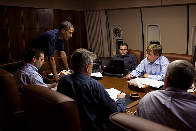 President Barack Obama is briefed during a flight to Moscow, 2009