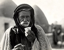 Syrian Bedouin from a beehive village in Aleppo, Syria, sipping the traditional murra (bitter) coffee, 1930 Bedouincoffeecup.jpg