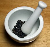 Black peppercorns with mortar and pestle.jpg