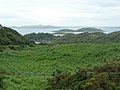 Bracken slopes down to Loch an Eisg-brachaidh The islands in Enard Bay beyond.