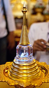 A relic found amid the ashes of Chan Kusalo (the Buddhist Patriarch of Northern Thailand) is placed inside a chedi shaped vial and displayed inside Wat Chedi Luang in Chiang Mai. Chan Kusalo cremation 51.jpg