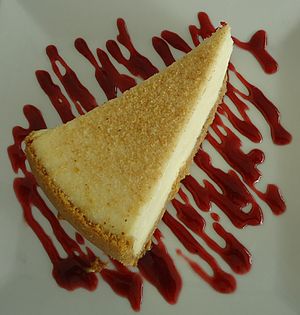 Cheesecake served with sauce in a restaurant.jpg