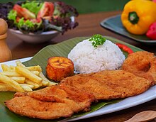 Cutlet "Valluna", a typical dish of the Valle del Cauca region of Colombia and the Afro-Colombian culture of the area near the Pacific Ocean. It includes a milanesa, usually prepared with a lean pork loin beef or chicken can also be used. Traditional accompaniments include rice, sliced tomatoes, onions, chopped fried plantains or fries and a drink called "Lulada" made with lulo fruit, water and sugar Chuleta Valluna - Colombiana.jpg