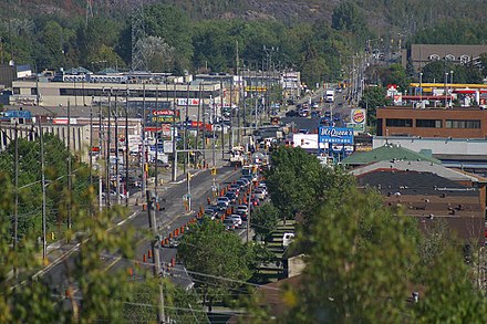 Barry Downe Road in Sudbury, with several businesses in the service sector visible. By 2006, 80 percent of Greater Sudbury's labour force was employed in the service sector.