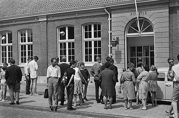 Journalists waiting on news of Team Lotus boss Colin Chapman, who was arrested for assaulting a police officer