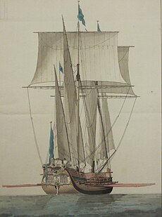 A sailing ship with raised sails seen from the stern. Along its sides it has a single row of cannons. Between the gunports, a single row of large oars is protruding.
