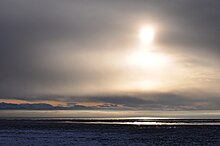The mouth of Turnagain Arm at low tide in winter; thousands of icebergs lie stranded on vast plains of glacial silt