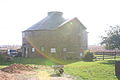 Exterior of the round barn own by Ron and Cindy De Mexico on Montague Road, Byron Township, Ogle County, Illinois, USA. A true round barn, tile, no cupola, conical roof, and large hay dormer on the north side.