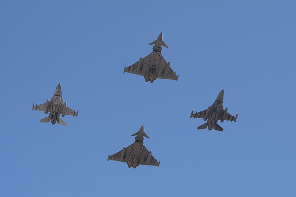 Romanian and US F-16s fly in formation alongside British and Italian Typhoons.