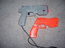 Popular GunCon light guns. The bright orange illustrates the toy-like appearance of most light guns, whereas the grey example appears more realistic. GunCon 1 and 2.jpg