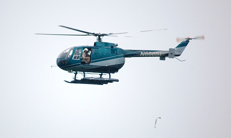 File:Helicopter distributing aerial mouse baits USDA (9601697356).jpg