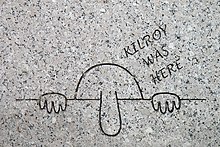 An engraving of Kilroy on granite, with eyes peering over a bar, and a large nose featured prominently
