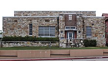 The stone Marie Heineke Memorial Gym is a product of the Work Projects Administration. Marie Heineke Memorial Gym West Elevation 2018.jpg