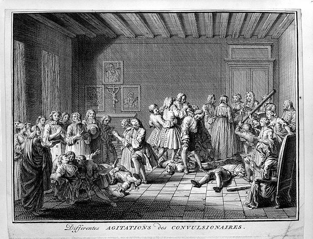 Members of the Jansenist sect having convulsions and spasms as a result of religious fanaticism. Engraving by Bernard Picart.