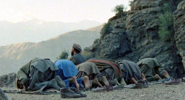 Afghan mujahideen praying in the Kunar Province, Afghanistan (1987)