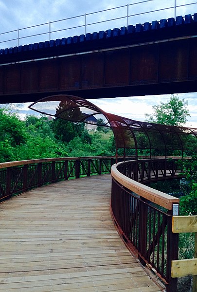 Multi-use trail over Caruthers Creek. The overhead bridge carries a Canadian Pacific rail line.