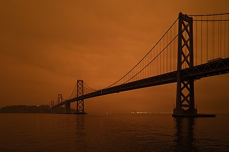 "North_Complex_smoke_in_San_Francisco_-_Bay_Bridge_partially_illuminated,_Yerba_Buena_Island,_and_Oakland.jpg" by User:Mxn