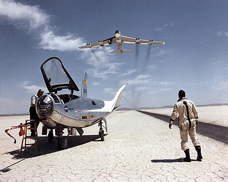 A NASA Boeing B-52 Stratofortress flying over a Northrop HL-10 and its pilot William H. Dana in 1969