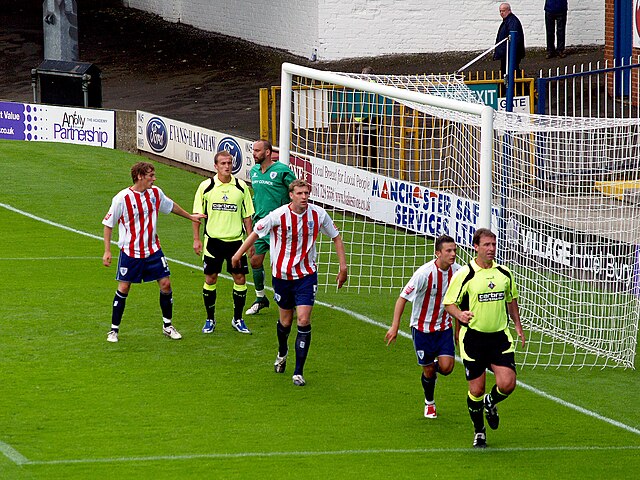 Oldham Athletic (in yellow) in a friendly match against Bury during the 2009–10 season
