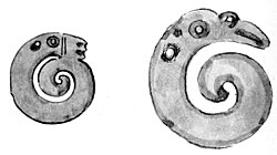 Two greenstone carved manaia each in the shape of a coiled snake.